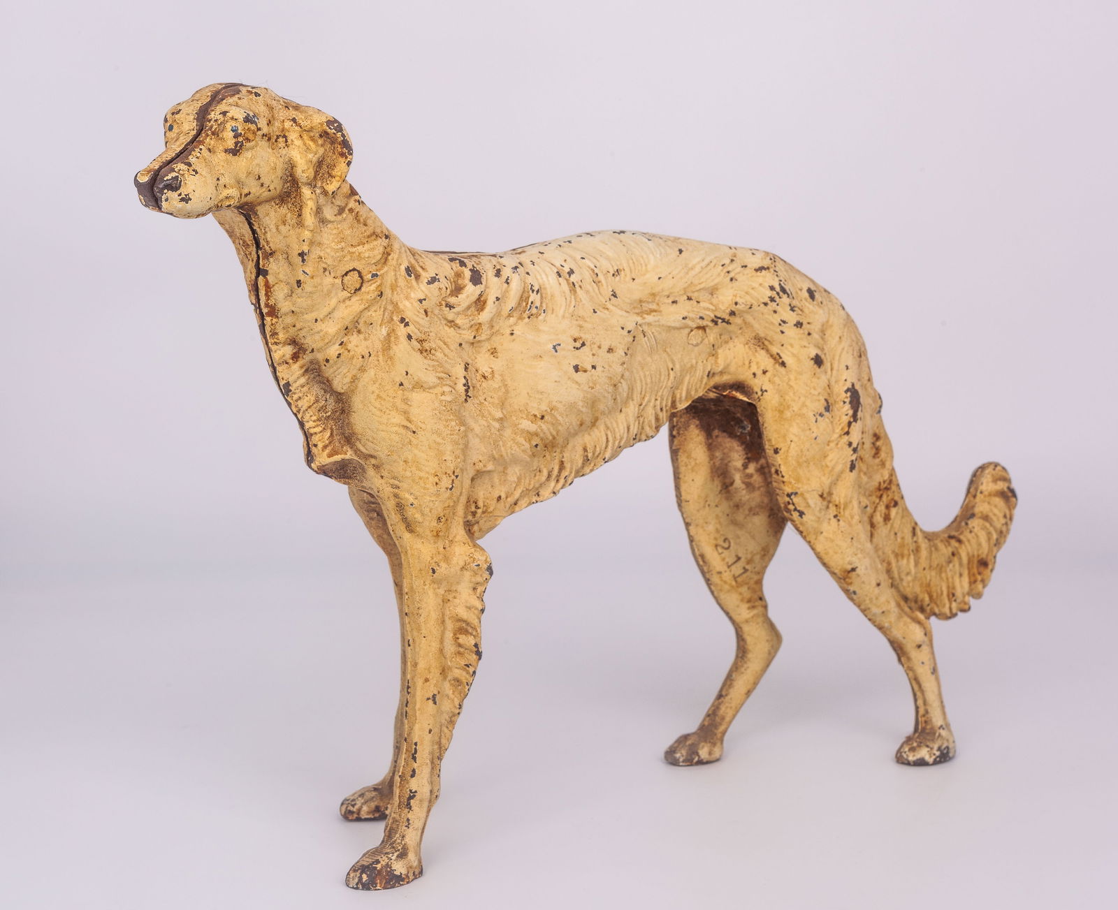 Art Deco Cast Iron Wolfhound Dog Doorstop.: The maker is unknown. This art deco piece is stamped, "211". The dog looks to be a white Borzoi, though there is a fair amount of paint loss, and some dinginess. Otherwise, the piece looks to be in go
