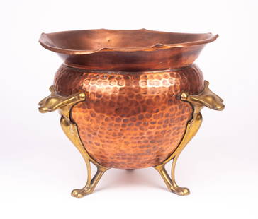 Arts & Crafts English Footed Planter w/ Copper.: This hammered pot has three brass paw feet leading up to three handles. There are some scratches and other signs of surface wear on the copper finish. The underside is stamped with the manufacturer's