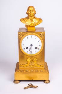 French Gilt Bronze Mantel Clock w/ Bust of Man.: The ormolu keywind clock features a bust of a man, likely an official. It has a crystal back, and no crystal in the front. The piece measures 11 1/4" x 5 1/2" x 4 1/4". It ticks. There are some cracks