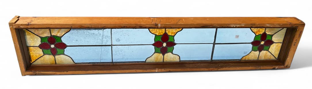 Large, Long Stained / Leaded Glass Window.: The window features three flower designs with stained glass around them. The rest of the glass is stained blue. The window measures 72" x 14" (including the wooden frame). There are some stains on the