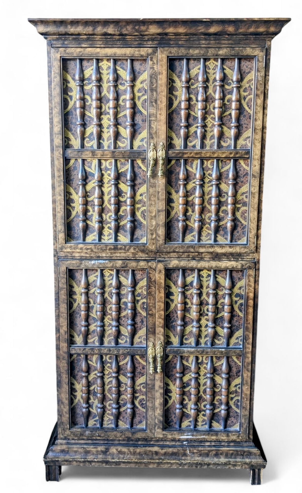 Tall Upright Kitschy Lighted Bar.: This bar has a spindle and gold painted design. The top doors open to reveal a storage area with two adjustable glass shelves, a pull-out surface, and a mirrored back. The lower doors house a storage