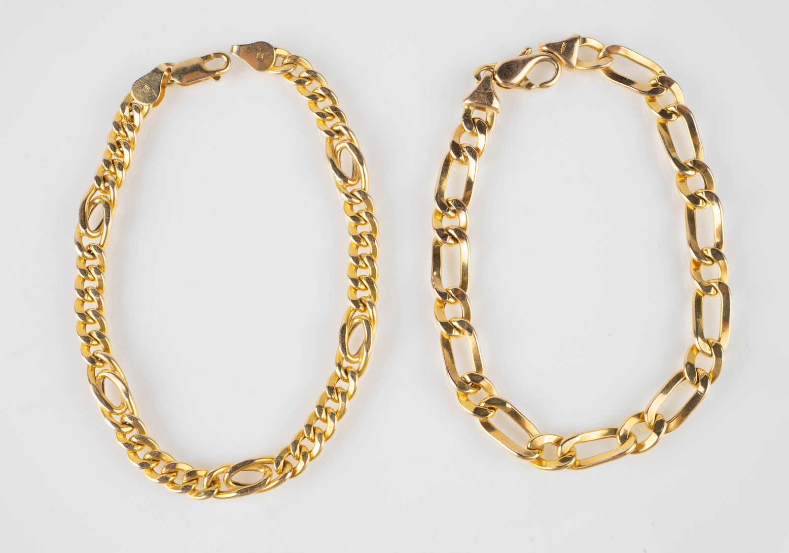 Lot of Two Italian 14K Gold Chain Bracelets.: The lot contains 2 gold bracelets with distinct chain links. One piece is marked 14K / Italy / M, and the other is marked 14K / Italy / MB. They measure 7 1/2" - 8 1/4" long, and the widest piece meas