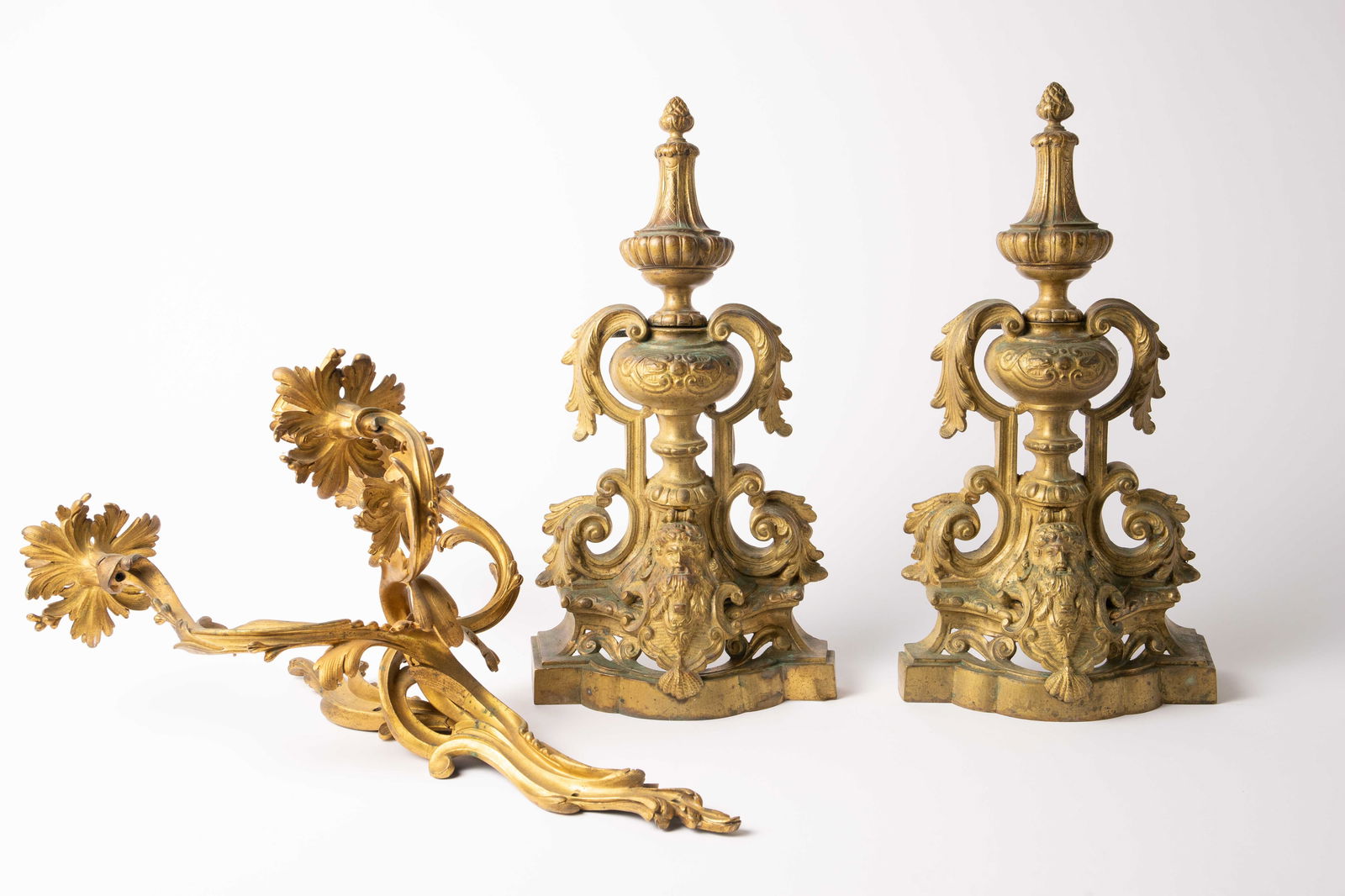 Antique French Bronze Andirons & Candle Sconce.: The lot contains 3 gilded bronze items. The pair of andirons are marked Made in France on the bases. They have a filigree urn design with a portrait figure on the bottom. They measure 18 1/4" x 9 1/2"