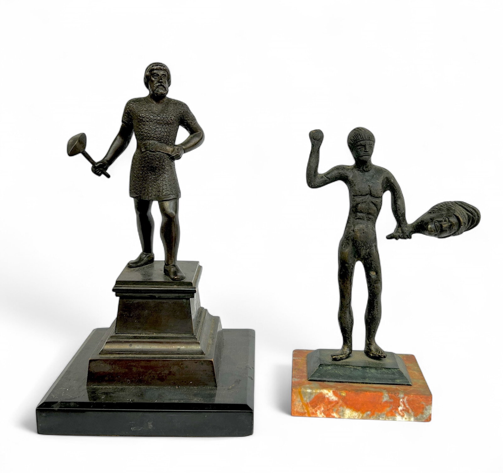 Lot of 2 Bronze Statuettes of Male Figures.: They are both on attached marble stands. Neither one appears to be signed. The larger piece is a man holding a hammer. It measures 5 1/8" x 5 1/8" x 9". The smaller piece is a primitive style depictio