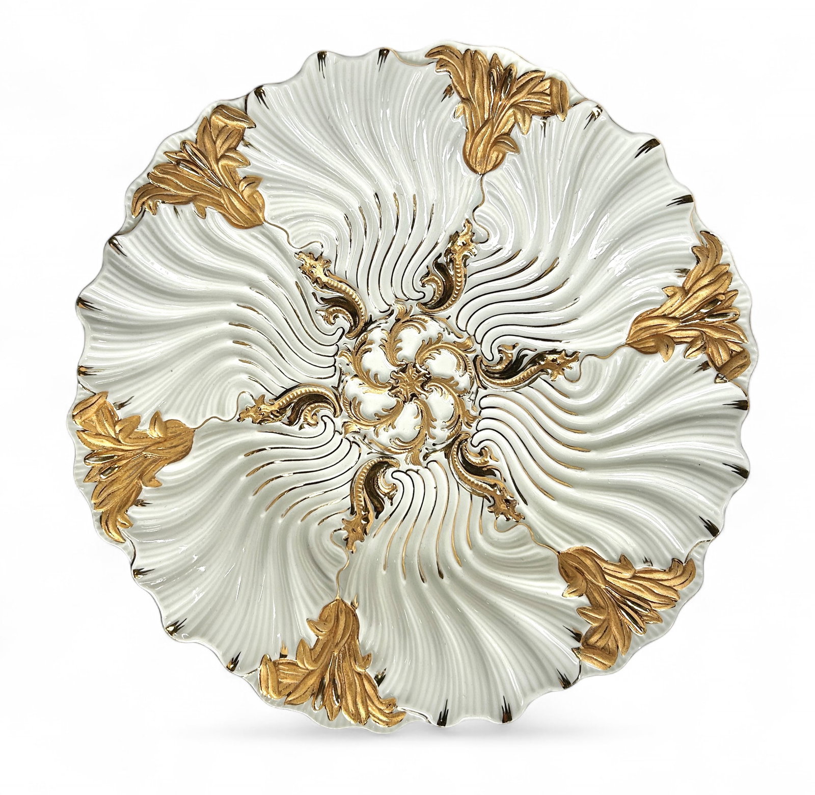 Meissen Porcelain White and Gold Pompous Bowl.: It has the blue crossed swords mark on the underside. The bowl has a wavy rim, a central image of a six pointed star shape, and six clusters of cattails and leaves along the border. It looks to be in 