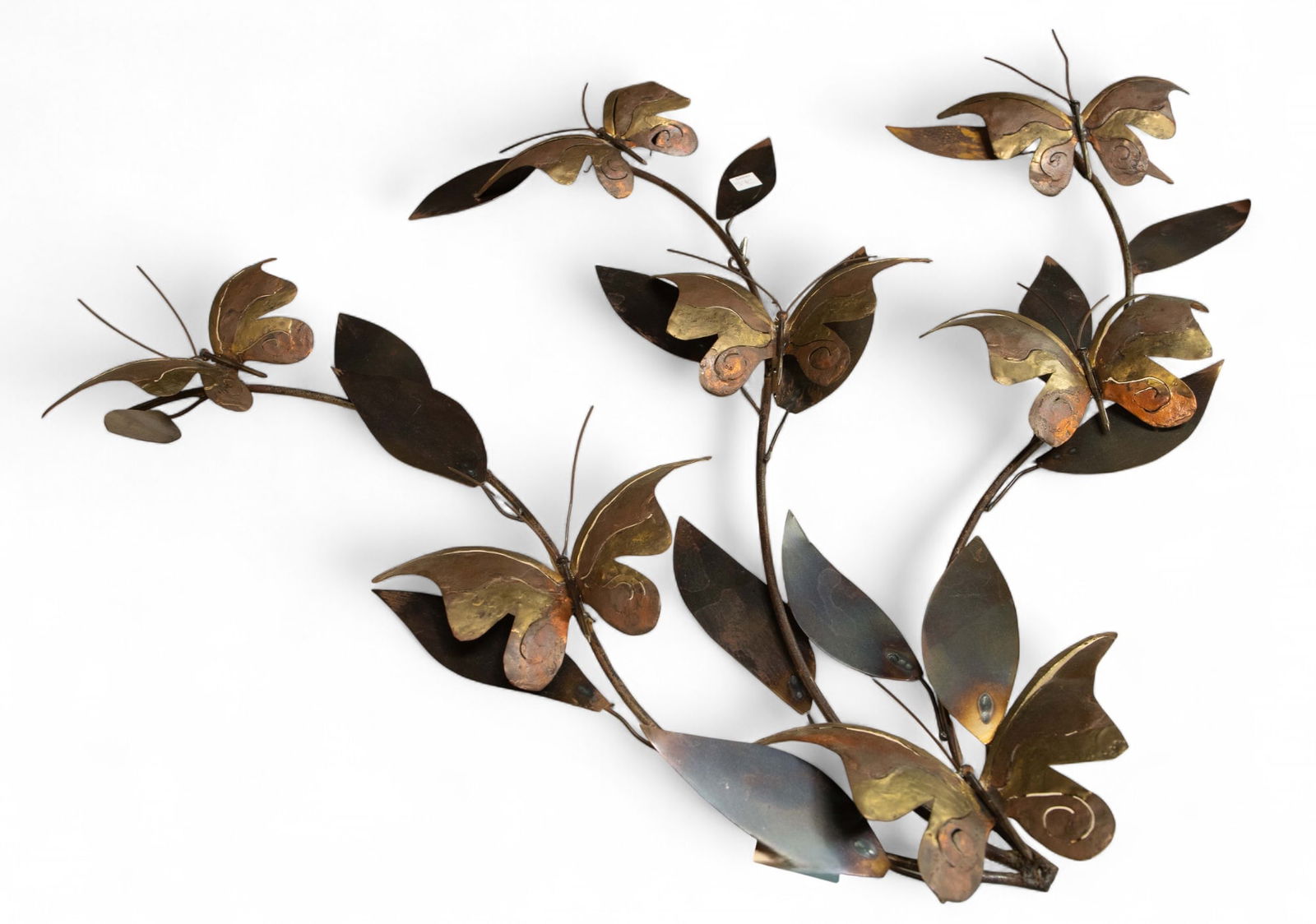 Curtis Jere ? Metal Butterfly Wall Sculpture.: This Curtis Jere style piece features a variety of metals or various metal treatments to create a multicolored sculpture. The sculpture depicts branches with 7 scattered butterflies, having bodies mad