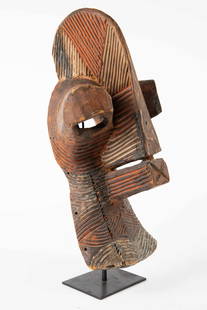 Songye Kifwebe African Dance Mask on Stand.: This carved wood mask is set on a lightweight iron stand. Some of the areas have red or black pigment. The mask measures 18" x 8 1/2" x 8 1/2" (not including the stand). With the stand, the piece meas