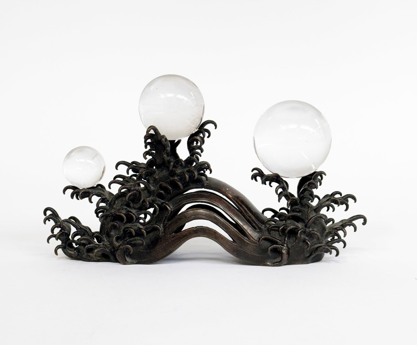 Japanese Meiji Period Bronze & Crystal Sculpture.: It is similar to the work of Takaumura Koun. It is in the form of a wave, wtih three crystal spheres atop it. It is in good overall condition. With the spheres in place, it measures 6 1/4" tall, 10" w