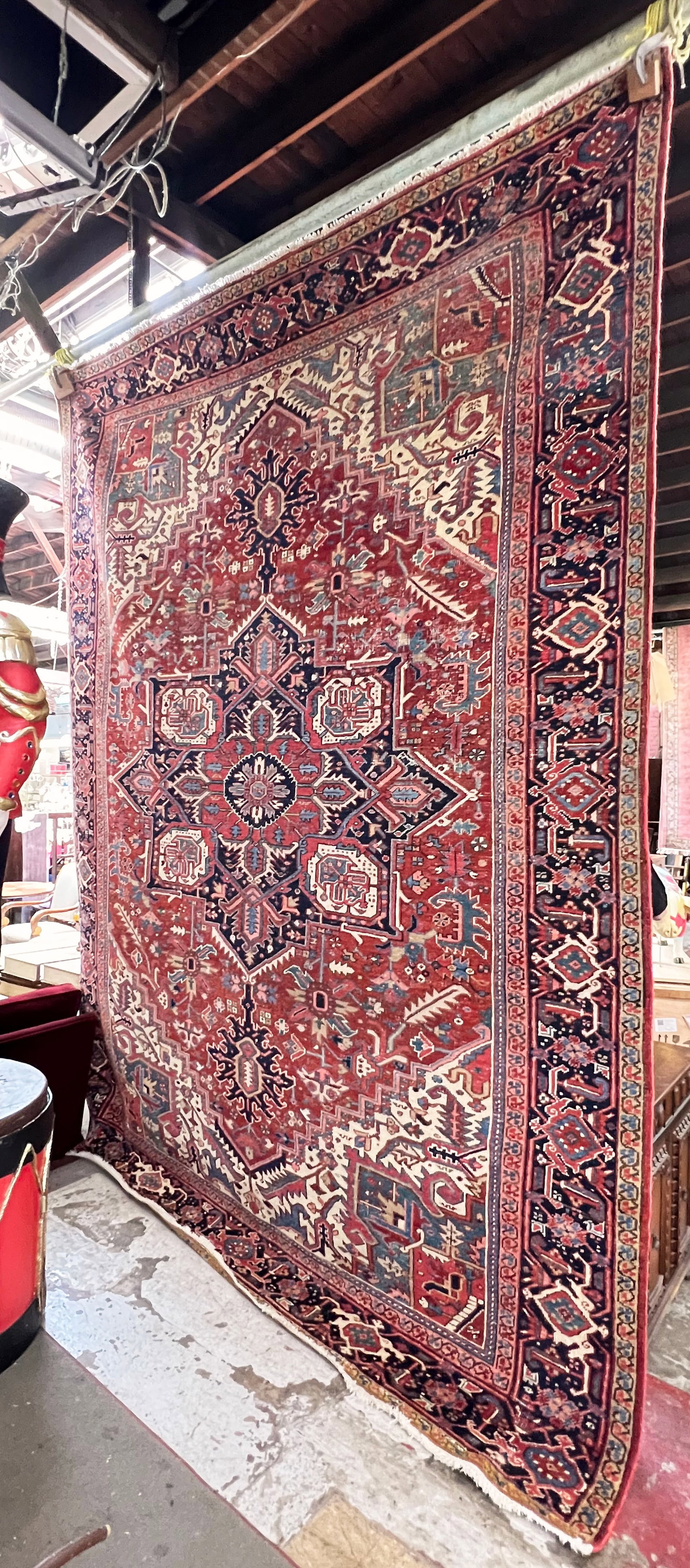 8' 5" x 11' 4" Heriz Rug.: The rug has many areas of wear throughout the overall pattern, so much so that the weft shows through in various spots. Other than that, it is in good overall condition. In-house shipping is available