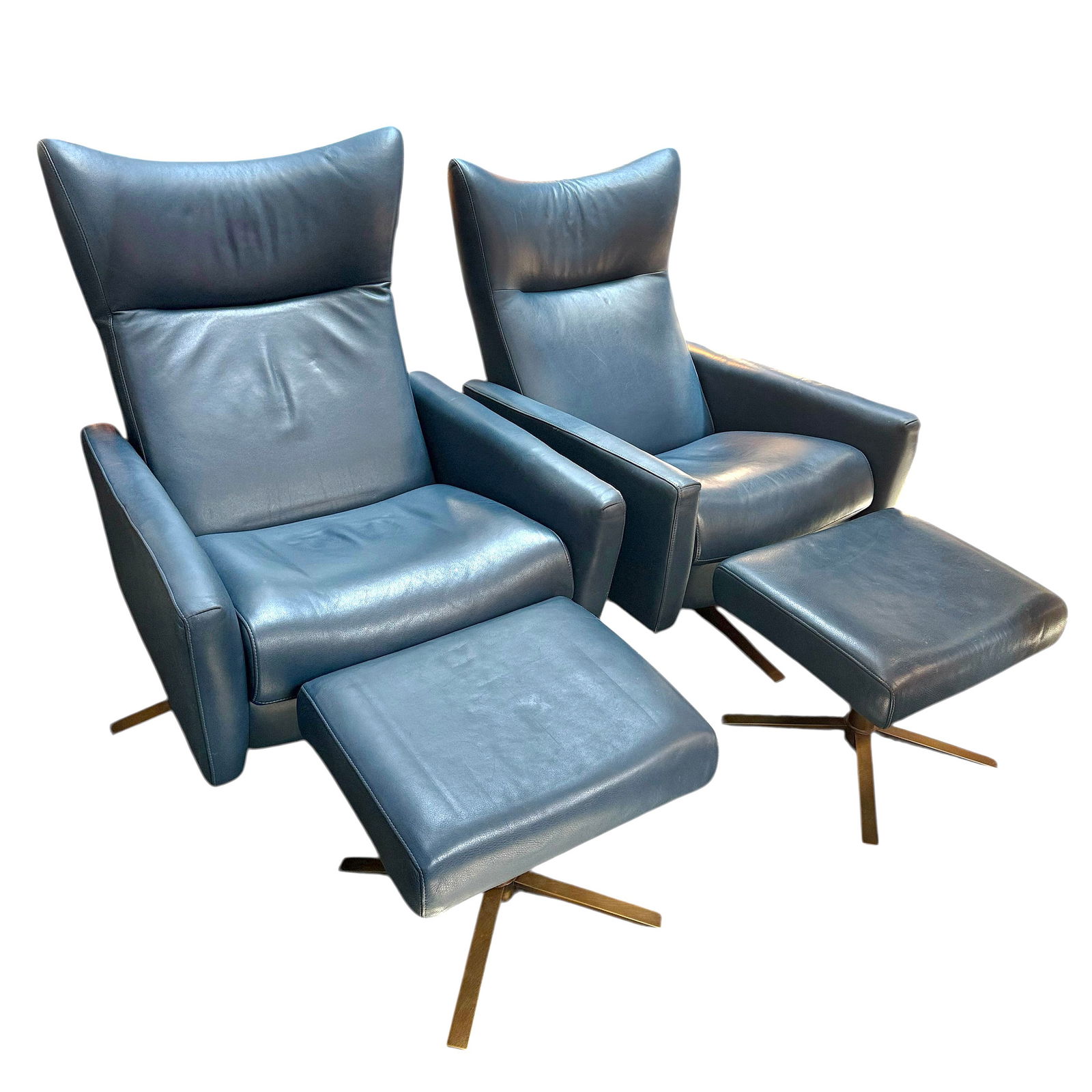 Pair of Leather Recliners with Ottomans.: The pair of quality leather recliners have brass 4 prong legs, and are upholstered in blue leather. These recliner sets were manufactured by American Leather Operations in Dallas, Texas. Each chair me