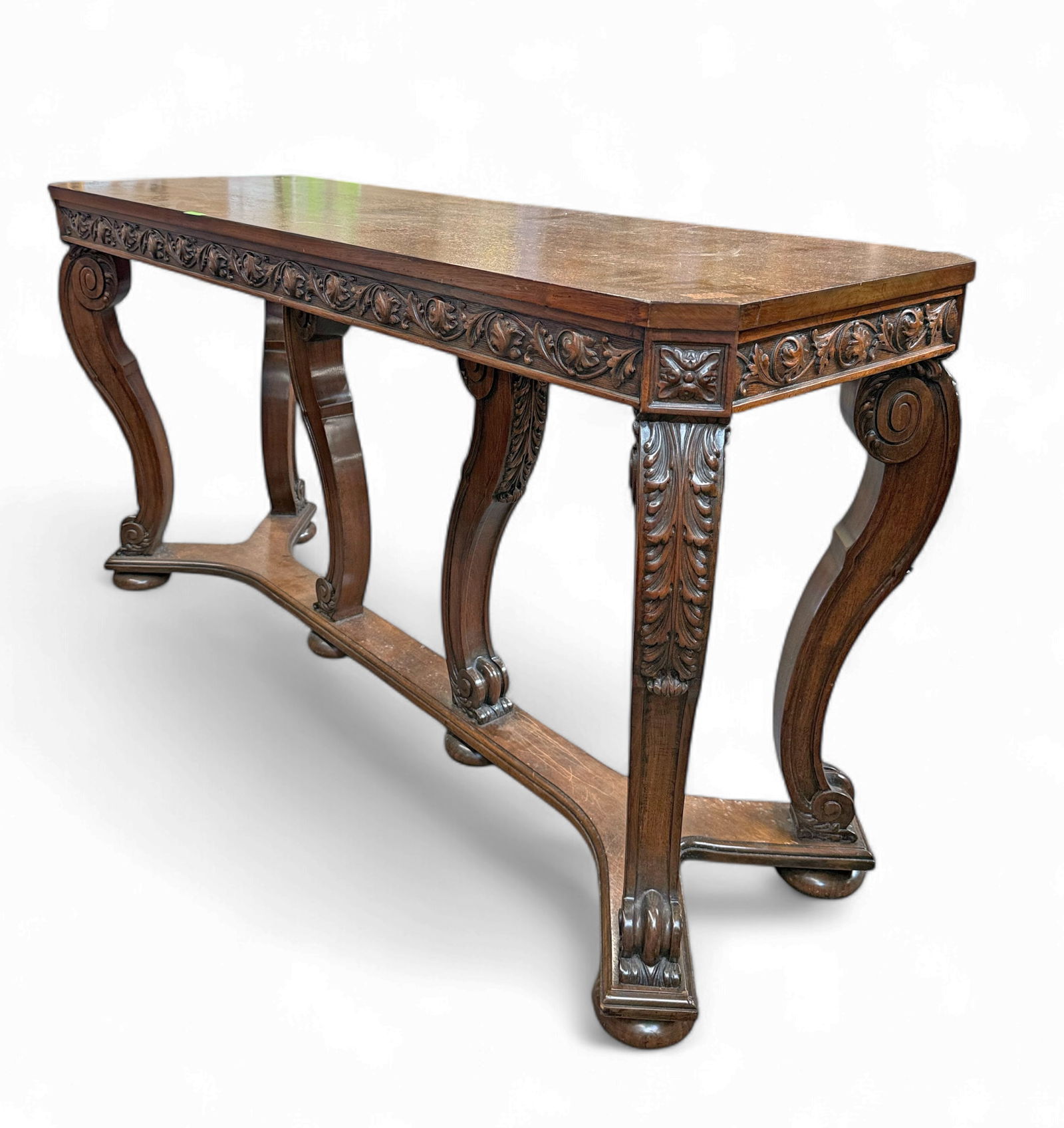 Antique Carved Wood Console Table.: The table features curved legs with scroll and leaf designs and a wide carved leaf trim all around. It measures 31 1/2" x 60" x 20". There are chips to the varnish and some scratches on the piece. Oth