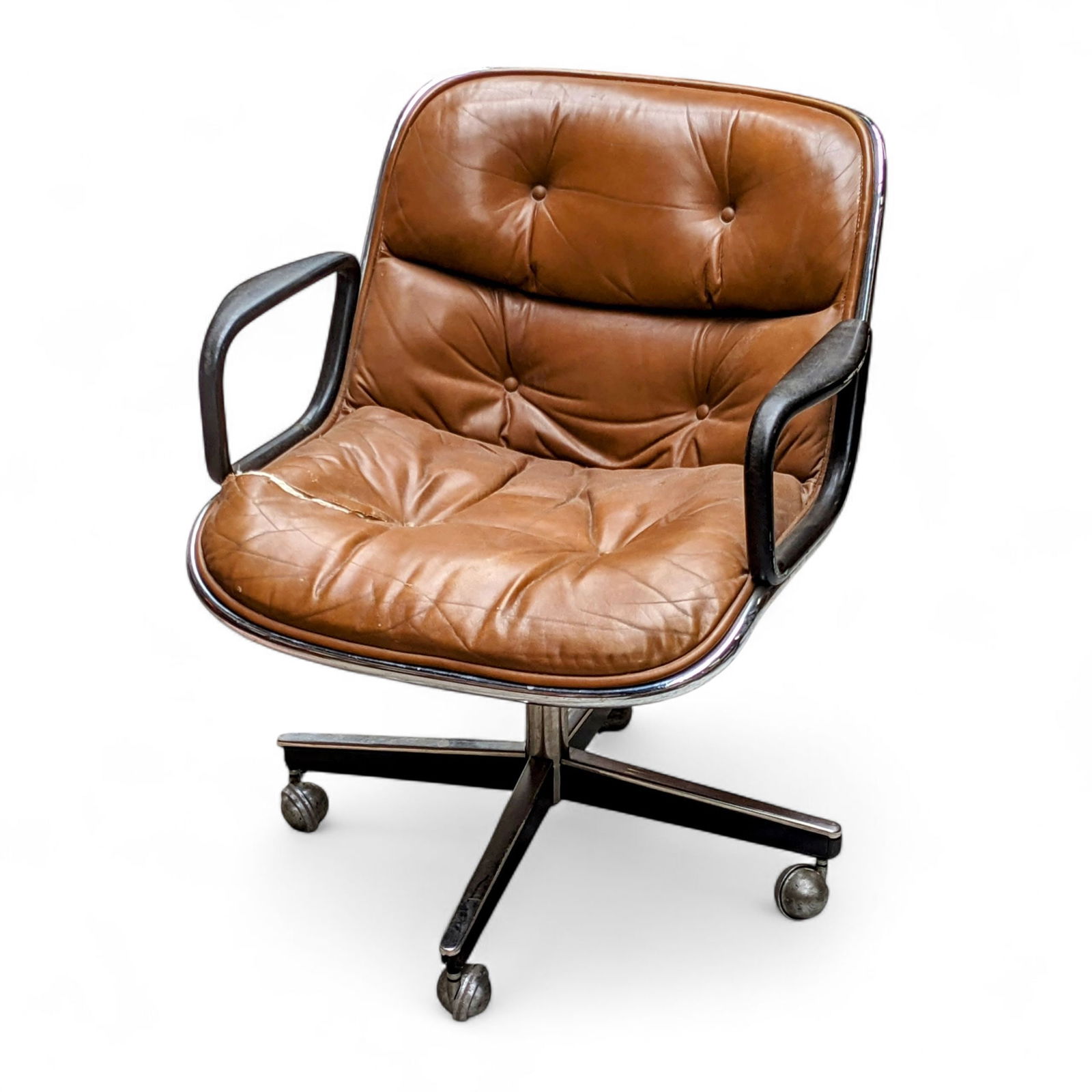 Knoll Charles Pollock Leather Chair.: The unlabeled tufted cognac leather and chrome swivel lounge chair was designed by Charles Pollock. It measures 26 1/2" wide, 26" deep, and 28" tall. There is a large tear on the seat, and some crease