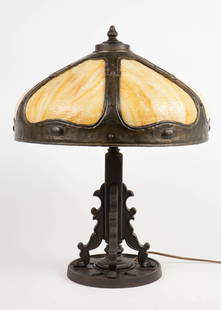Sgd. Miller Slag Glass Lamp.: The lamp has a six panel glass shade with a wrought metal frame. The lamp measures 23" tall, with the shade measuring 17 1/4" in diameter and 10 3/4" tall. It is signed in two places that are not
