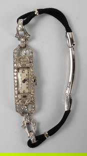Antique Platinum & Diamond Watch - Staehli Swiss.: The Art Deco watch is marked 10% Irid Plat. inside the case. The movement is marked Staehli Swiss, 17 Jewels, Unadjusted. The rectangular case is covered in small round diamonds and two baguette cut p