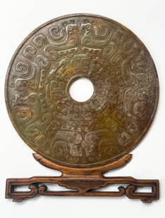 Possibly Han Dynasty Large Chinese Jade Bi Disc.: It comes with a partial wood stand, which is missing its back piece. The disc is in good overall condition, with wear to use. It has a beautiful natural patina. Provenance: From an American Collection