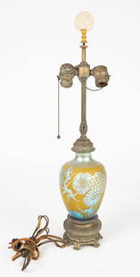 Steuben Yellow Jade Blue Aurene Acid Cutback Lamp.: This acid etched lamp has a flower motif, and sits atop a bronzelike base. It looks to be all original. There are some scratches and smudges on the glass, and some surface wear on the metal. The carve