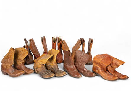 Lot: 9 Pair of Leather Cowboy Boots.: The lot includes a variety of brown toned cowboy boots, some with embroidered designs. The brands or marks observed on the boots are Lucchese San Antonio, Larry Mahan, Justin, Dan Post, and Made in Me