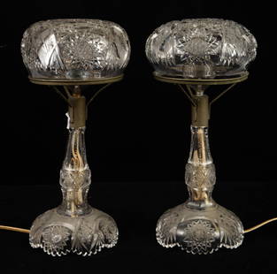 Pair of Cut Crystal Table Lamps.: The pair of lamps have matching cut crystal shades. They measure 13" x 5 3/4". There are a few scratches on the pieces, and the metal is aged. Otherwise, the lot is in overall good condition. In-house