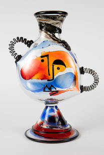 Mario Badioli 22" Murano Glass Face Vase.: This Picasso style vase has handles that resemble ears, splashes of blue, red, and black, and a conical footed base. The base is where the artist signature is found. Overall, this piece looks to be in