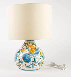 Italian Ceramiche Parrini Ceramic Table Lamp.: The Italian table lamp features a large ceramic base with hand painted birds, flowers, and scrolls in blue, green, and yellow, on a white background. The piece is stamped appropriately on the inside o