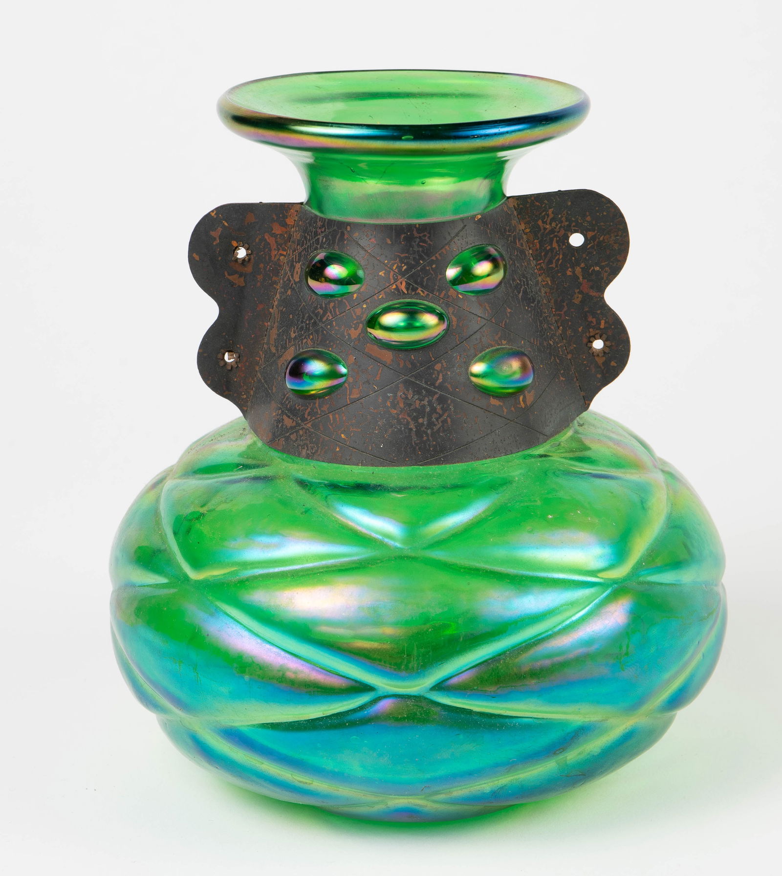 Loetz Style Iridescent Green Vase w/ Collar.: It is in the style of Loetz or Kralik, but may be Silvestri Glass. It has a fitted metal collar, with exposed knobs along the neck. Overall, it looks to be in good condition. It measures 7" tall and 6