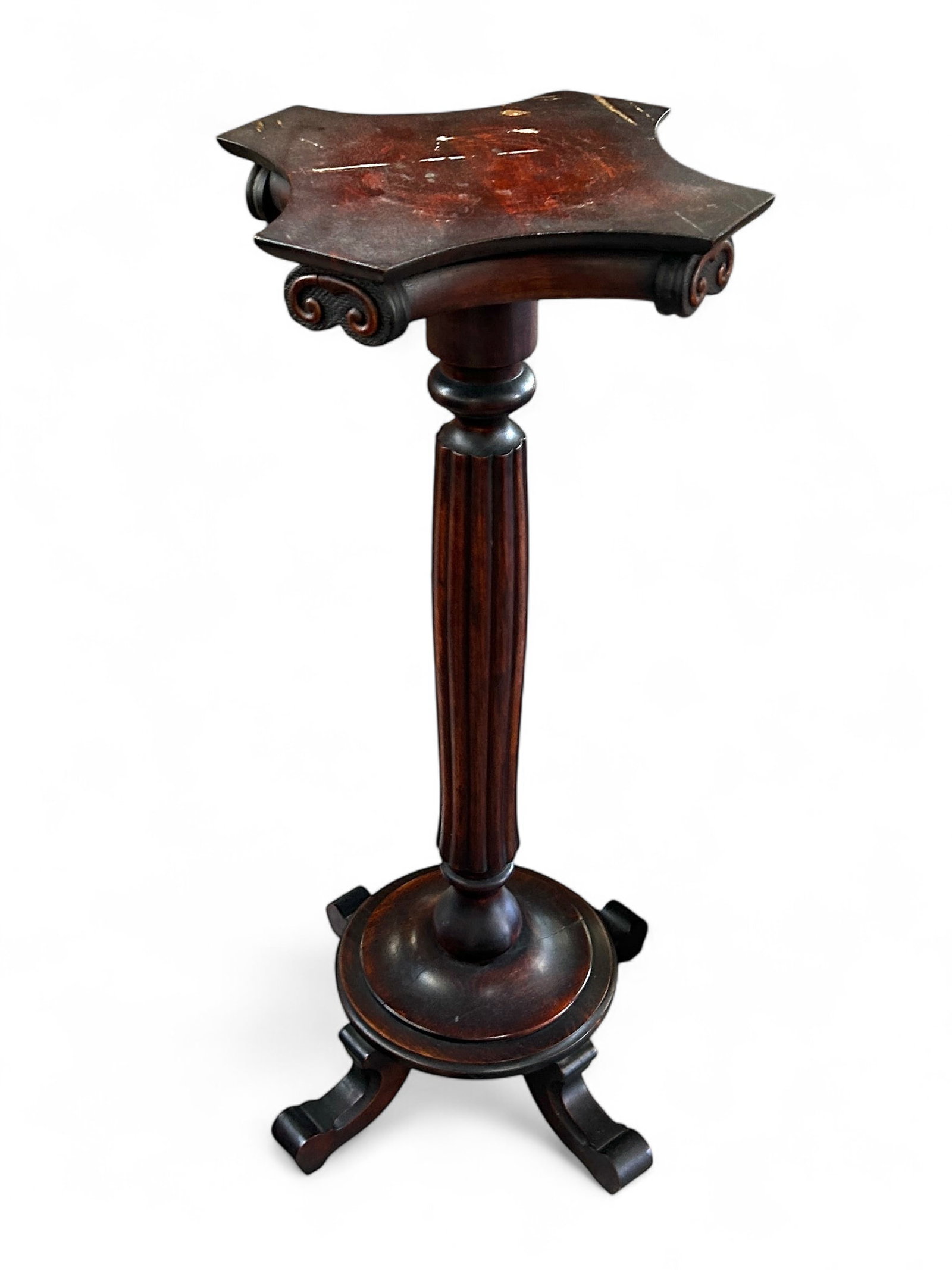 Carved Mahagony Pedestal.: This carved mahogany pedestal or plant stand has a column design and a carved apron and legs. It measures 36" x 15" x 14 1/2". There are some scratches and water spots on the top. Otherwise, it is in 
