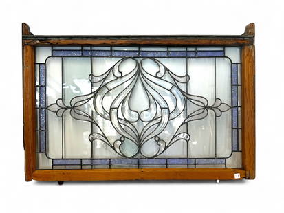 Bevelled Glass Window In Wood Frame.: It is a leaded glass window with a large central flower, surrounded by a textured stained glass border. It looks to be in overall nice condition, with one small crack that is difficult to notice. The