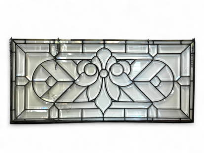 Rectangular Bevelled Glass Window.: This leaded glass window has bevelled panels, and a central design that resembles an upside down flower or fleur de lis shape. Overall, it looks to be in good condition. Because it has no frame, the w