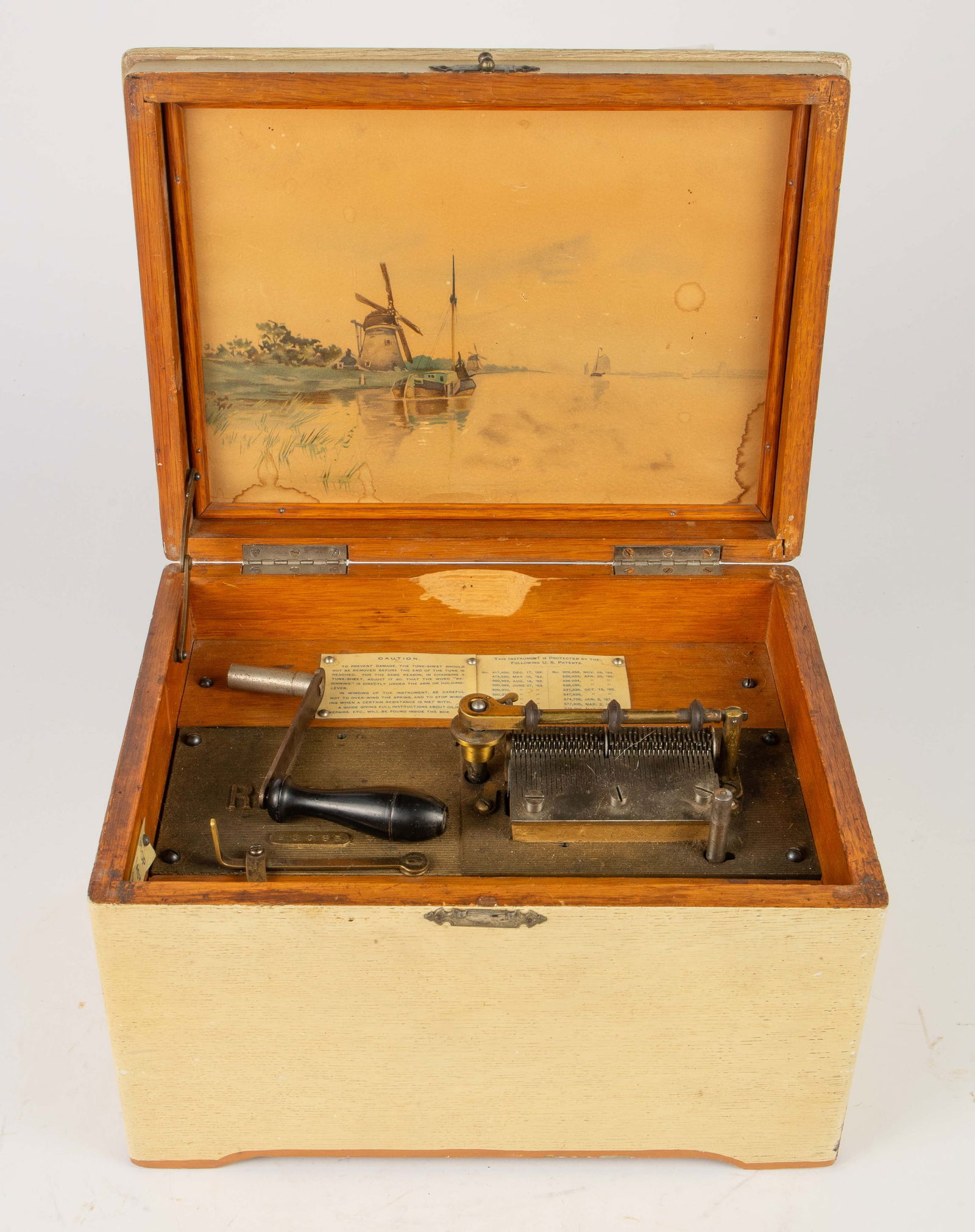 Regina 8" Disc Table Top Wood Music Box.: It comes with a crank. The central spindle turns when the piece is cranked and switched on. All the teeth on the comb are intact, so theoretically, it should play. There is no disc included to test th