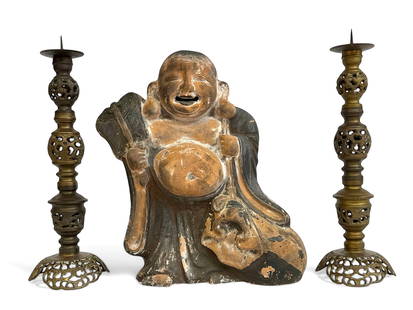 Clay Asian Buddha & Pair of Brass Candlesticks.: The buddha is holding a fan with luck and longevity symbols. The clay buddha has many areas of discoloration. He is in reasonably good overall condition. The buddha measures 14 3/8" tall, 12" wide, an