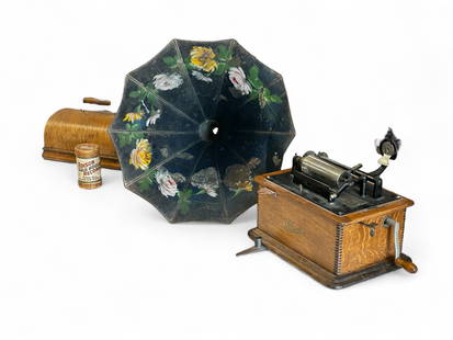 Thomas A. Edison Standard Phonograph w/ Tole Horn.: The small, portable phonograph is serial number 53136. It comes with an Edison Gold Moulded Record no. 8650, and a black hand painted floral sound horn. Whatever attaches the sound horn to the reprodu