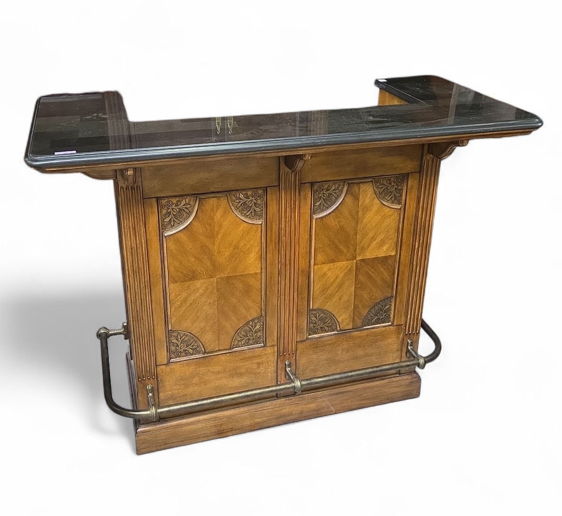Hooker Furniture Seven Seas Bar.: The bar has a tessellated granite ? top, panelled front, and a rail along the outside. The backside of the bar has two felt-lined drawers, a door, and an open storage area. Besides some scratches on t