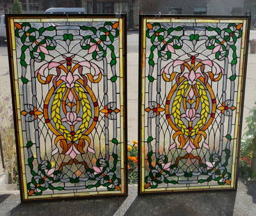 Pair of Stained Glass Windows with Flower Motif.: The contemporary leaded stained glass windows have wreaths, flowers, and jewel-like orbs throughout their design. Both have hanging loops at the top. They are in very nice condition. Each one measures