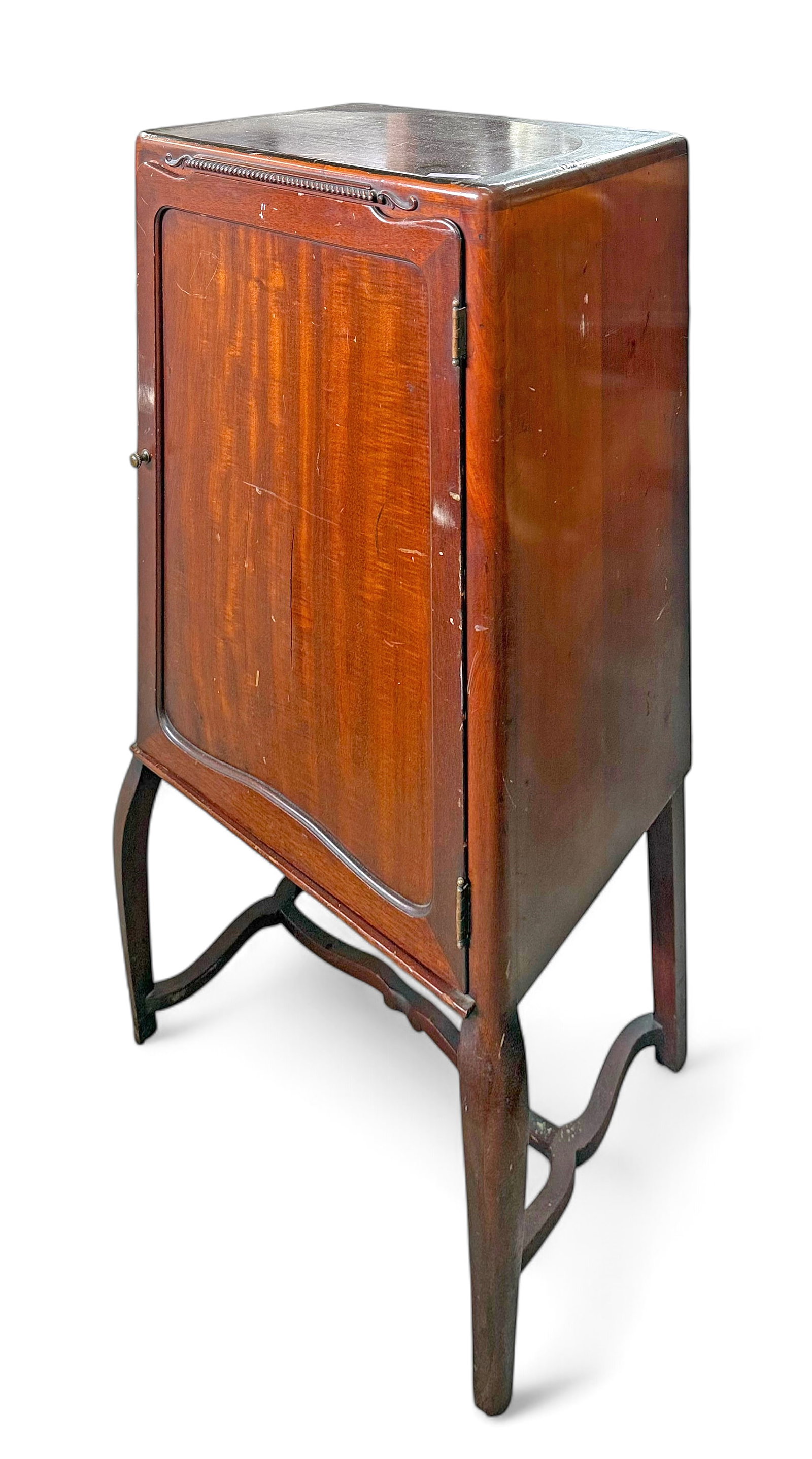 Antique Mahogany Music Cabinet.: The piece has curved front legs, carved trim at the top, and a brass knob. The inside of the cabinet has 5 removable shelves. It measures 38 1/2" x 19" x 15 1/4". There are a couple of veneer cracks o