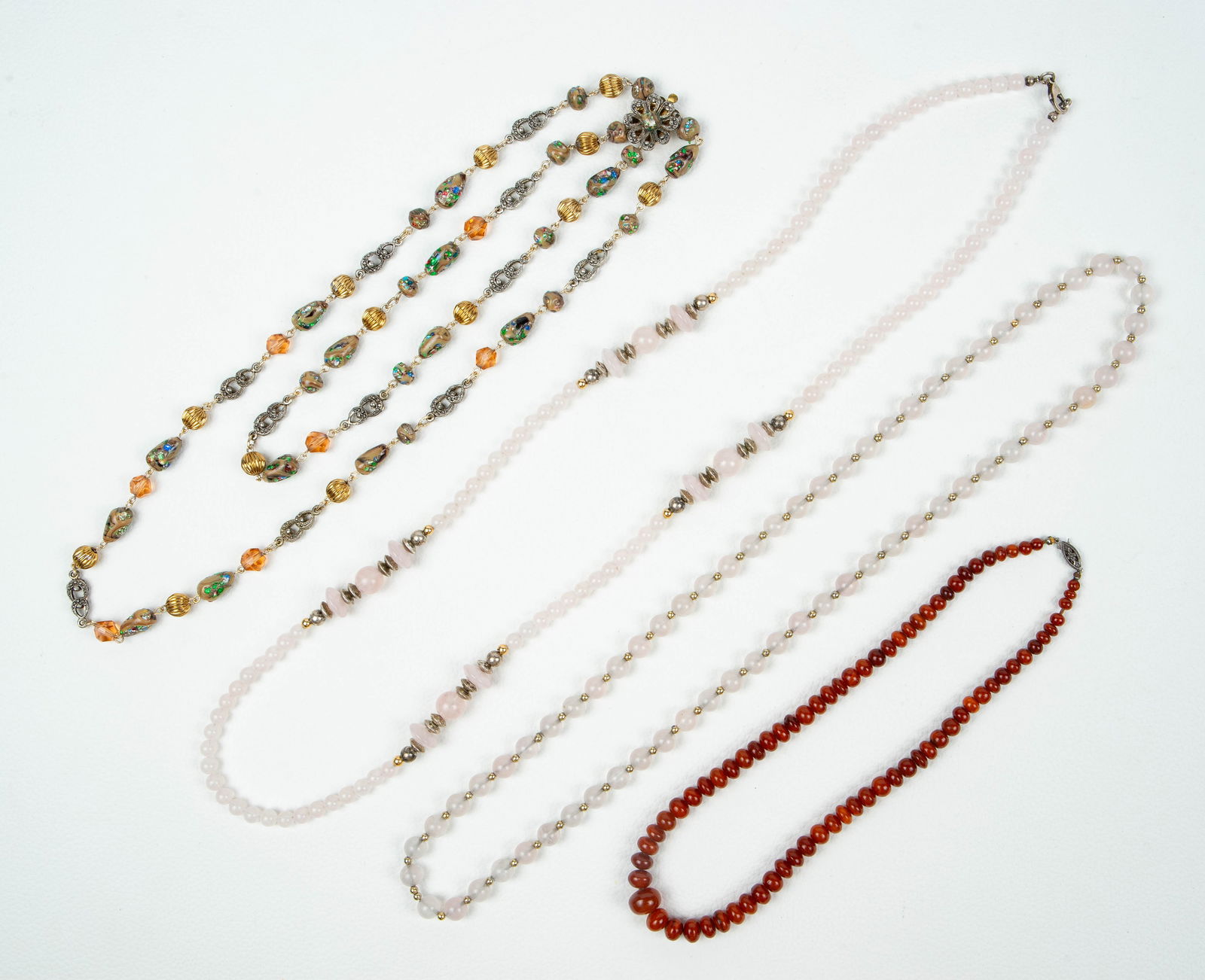 Lot of 4 Necklaces - Japan, Rose Quartz, 925.: The lot contains 4 vintage necklaces. There are 2 rose quartz necklaces with sterling silver bead accents, and a graduated amber necklace. There is also a vintage necklace marked Japan, which has a la