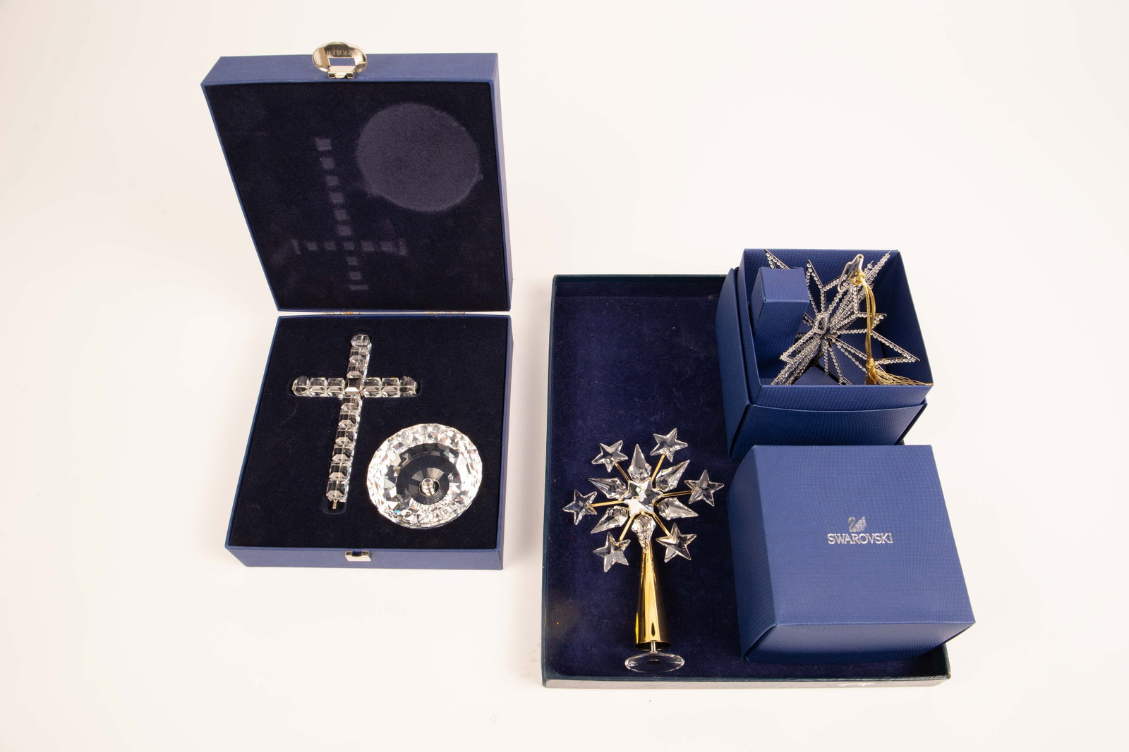 Swarovski Crystal Lot: Ornament, Cross, etc.: This lot includes a snowflake Christmas ornament (which can also be used as a tree topper), another tree topper with a star motif (which can also serve as a freestanding table decoration), and a two-p