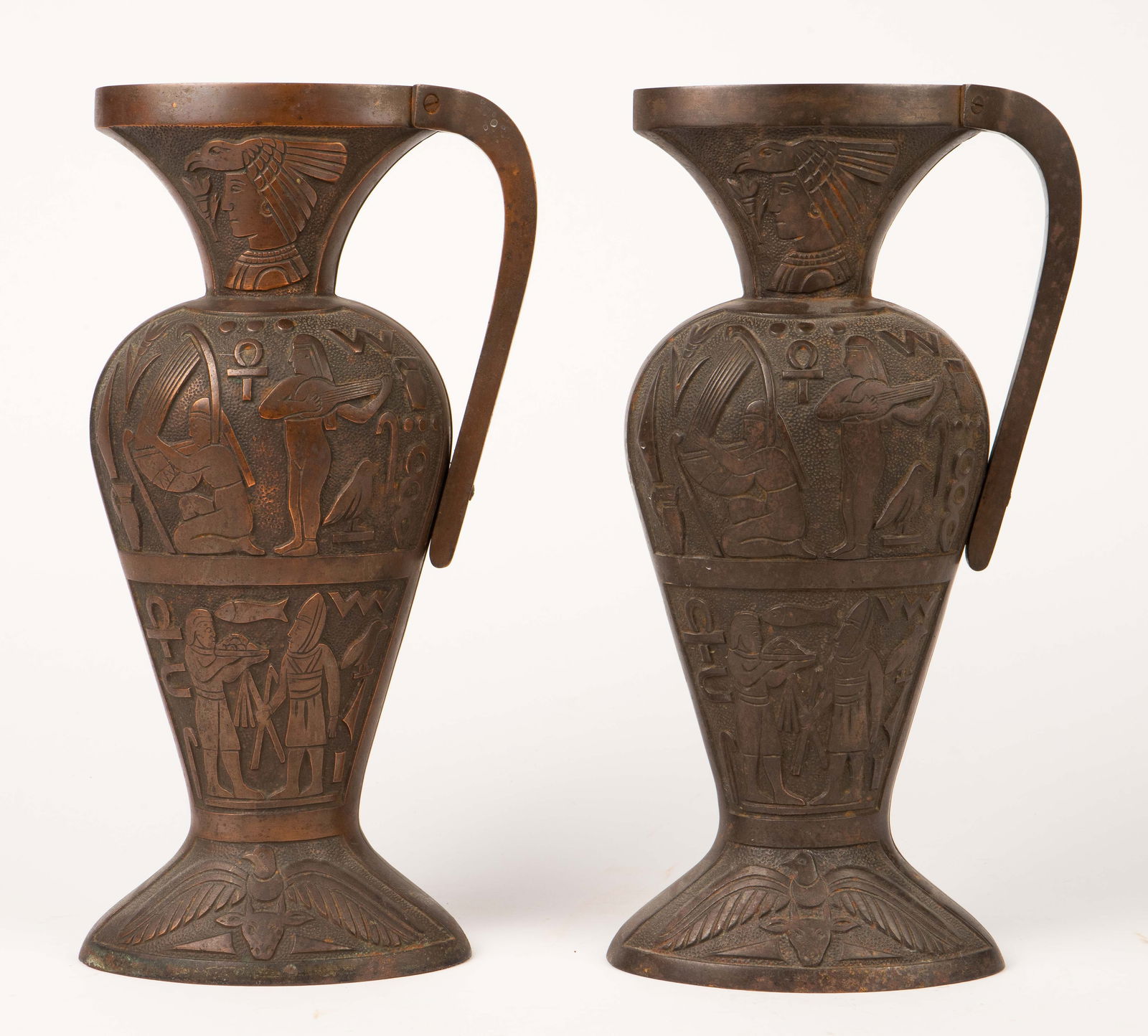 Pair of Cast Iron Egyptian Revival Decorations.: They resemble water pitchers, but are not functional as pitchers (they have open bottoms). They could be used as doorstops. Each has a bronze finish to it, giving the appearance of bronze, but they ar