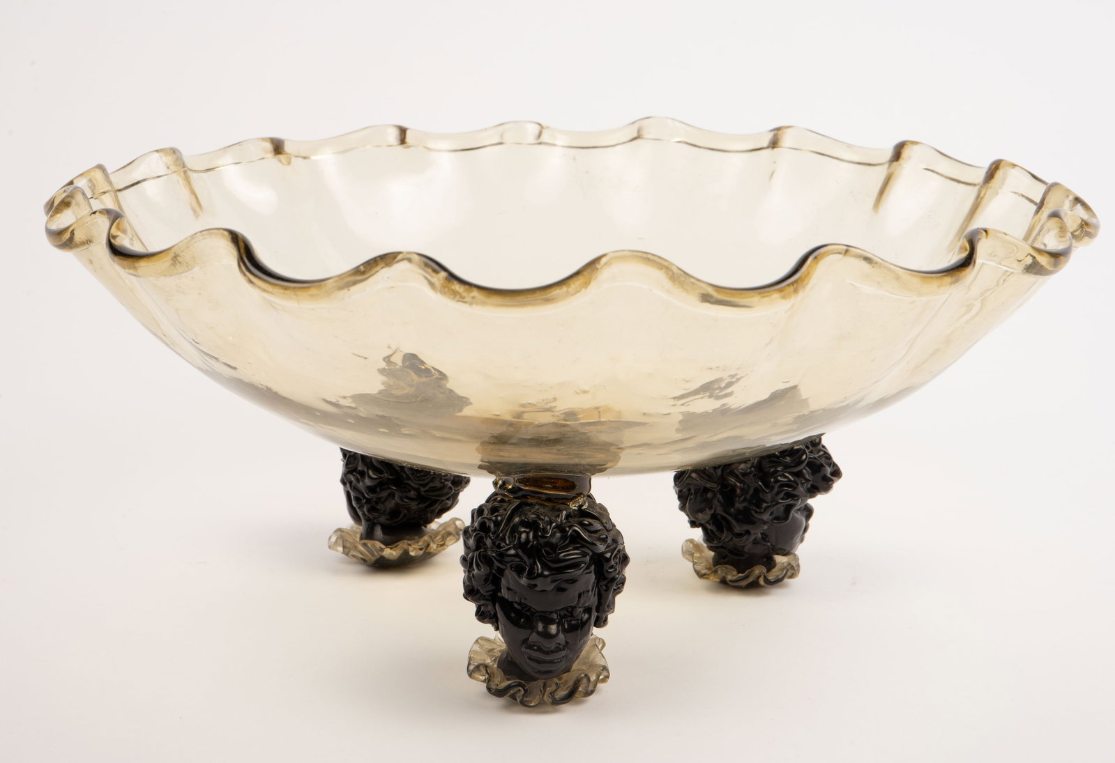 Murano ? Footed Art Glass Bowl w/ Blackamoor Heads: It appears to be unsigned. It is a ruffled rim centerpiece bowl with three nubian heads serving as a base. Aside from some scratches and a little dust, the piece looks to be in good condition. It meas