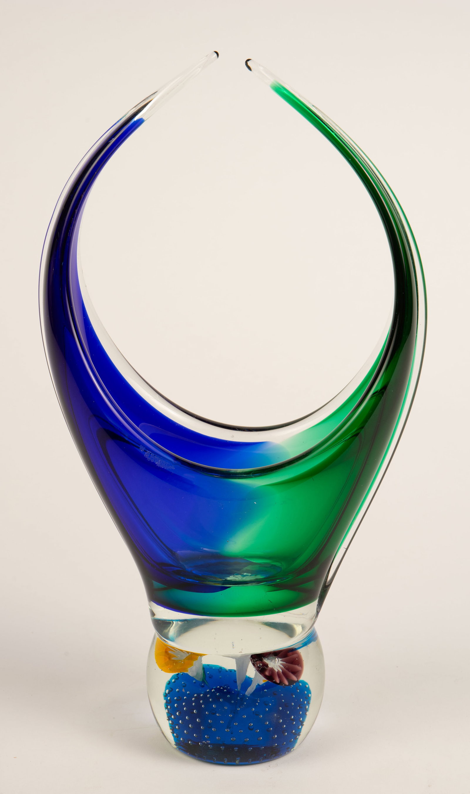 Murano ? Colorful Art Glass Vase w/ Flowers.: It appears to be unsigned. It is a basket shaped blue and green vase with flowers in the base. Overall, it looks to be in good condition. It measures 7" x 3 1/8" x 12 1/2". In-house shipping is availa
