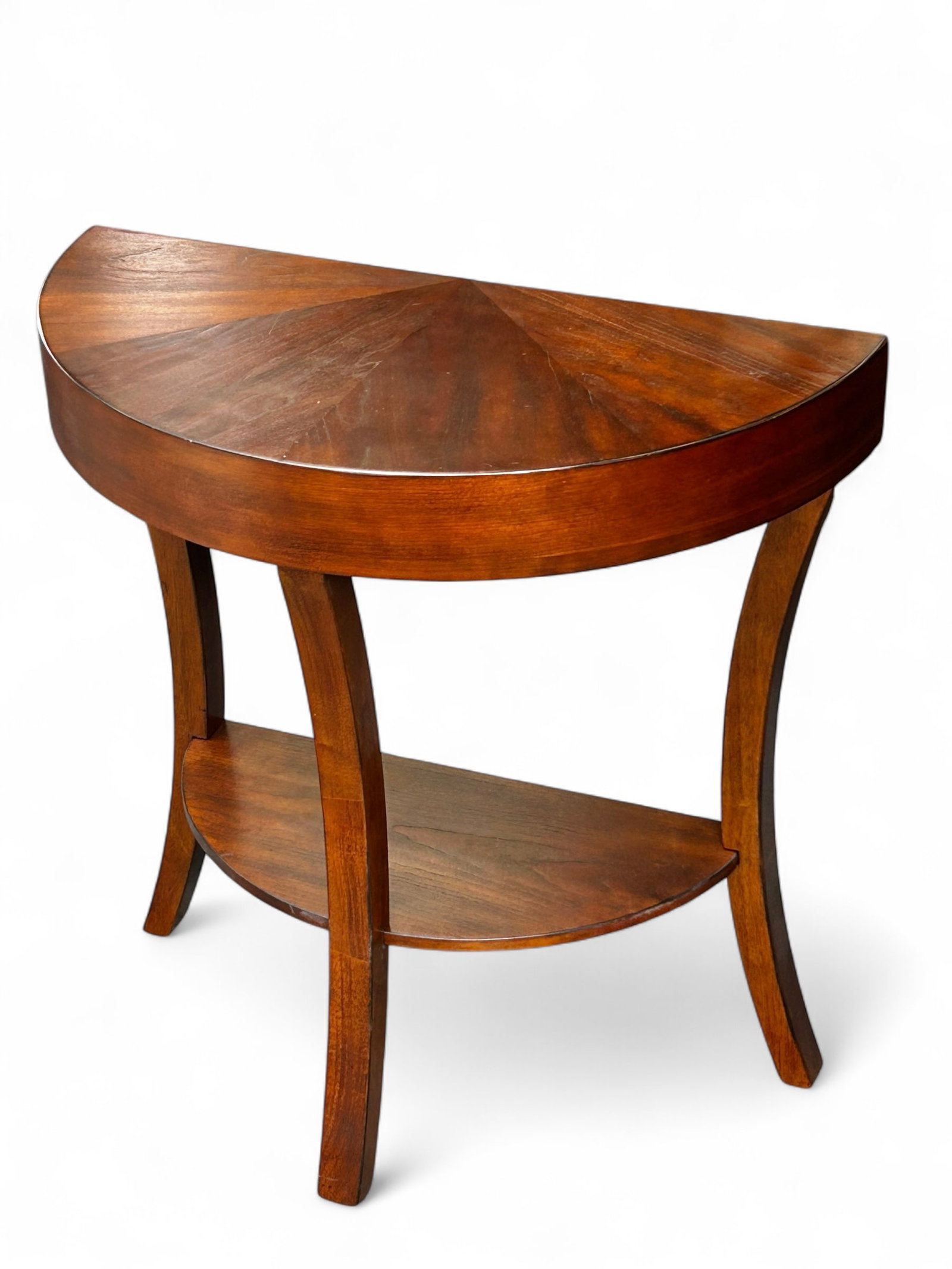 Contemporary Demilune Cherry Console Table.: This cherry wood table has a fixed lower shelf. It was manufactured in Malaysia. It measures 32" x 32" x 16". There is a small indentation on one corner. Otherwise, it is in overall good condition. Th