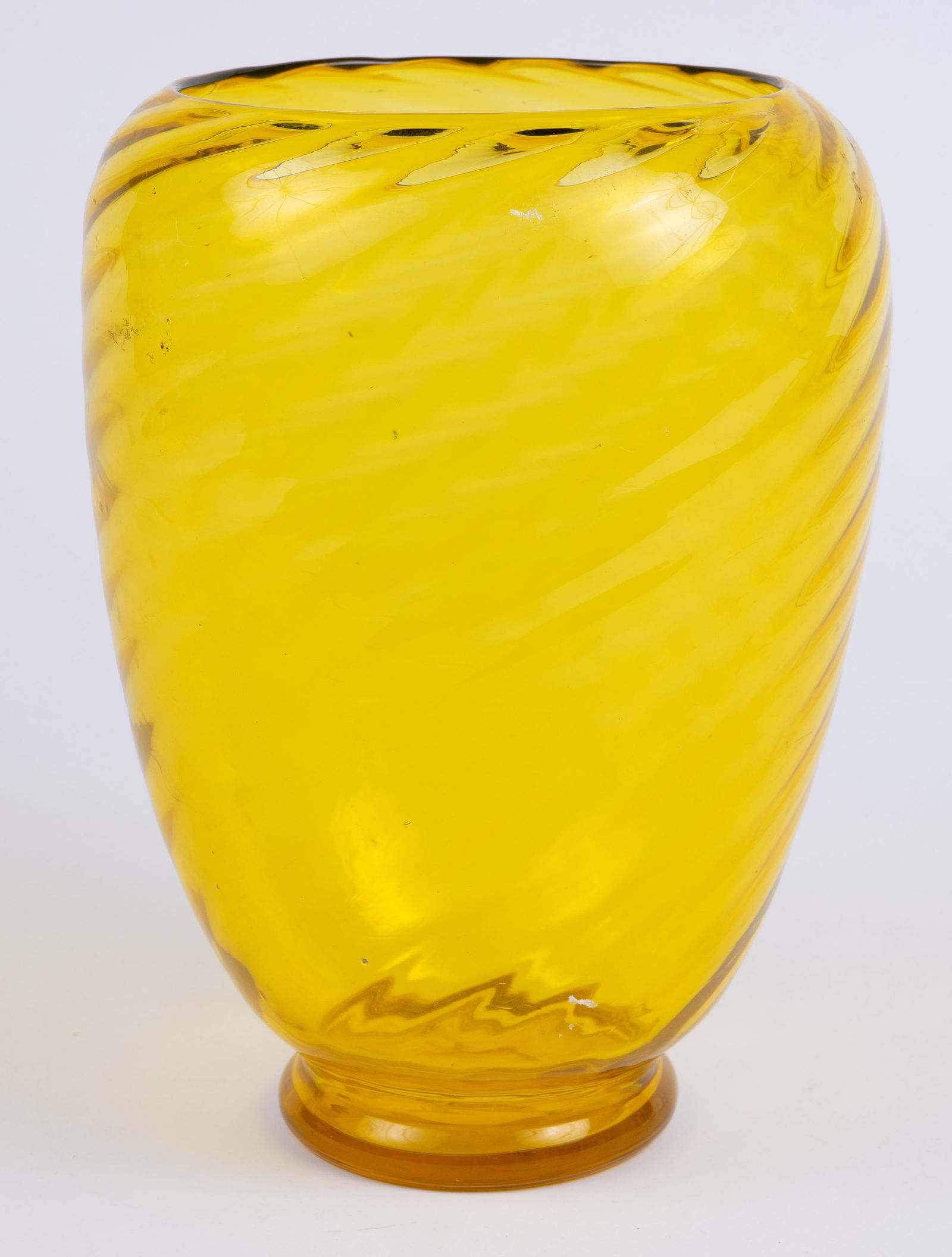 Steuben Bristol Yellow Optic Swirl Vase, Carder.: The yellow crystal vase features a diagonal ribbed optic swirl design. The piece is unsigned. It measures 9 3/4" x 7 1/2" x 7 1/2". There is a small chip on the base edge. Otherwise, the piece is in o