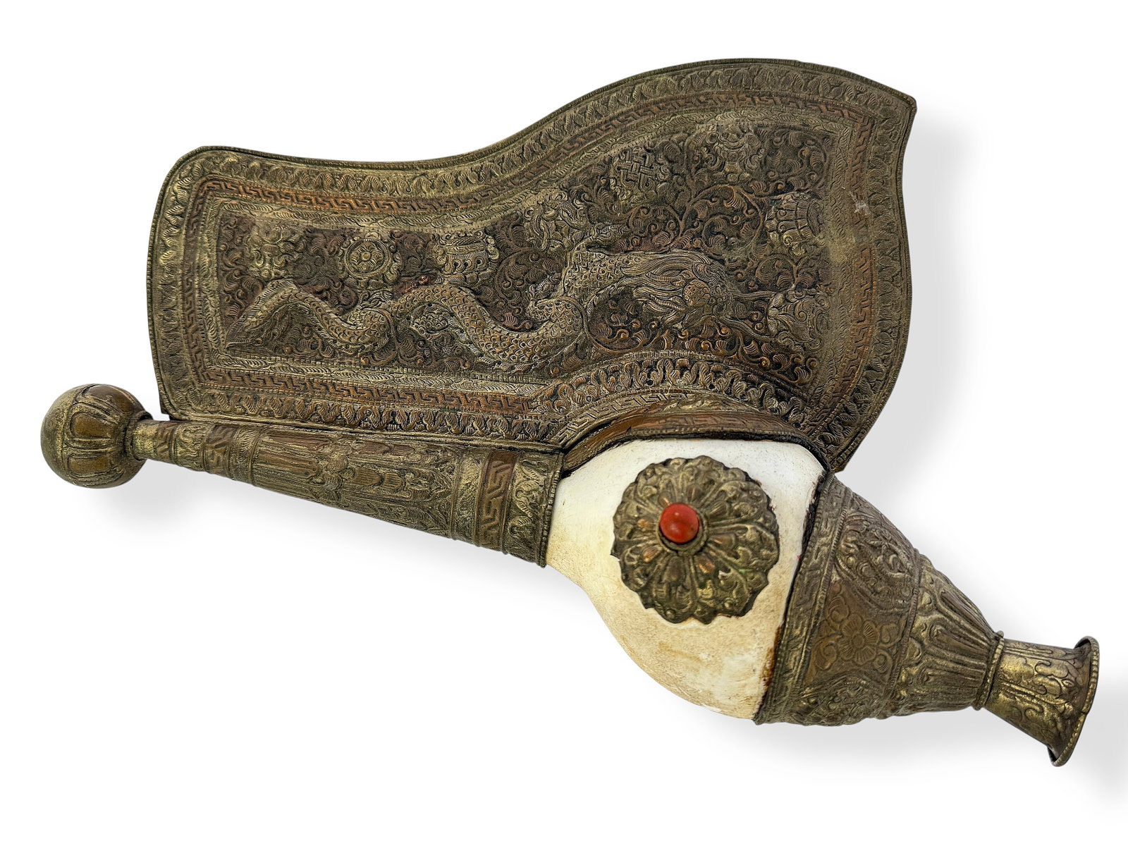 Tibetan Conch Shell Horn w/ Dragon Decoration.: The horn has a coral bead attached to it, in the center. It is most likely silverplate, and is in good overall condition. It measures 13" long, 9" wide, and 3 1/2" deep. In-house shipping is available