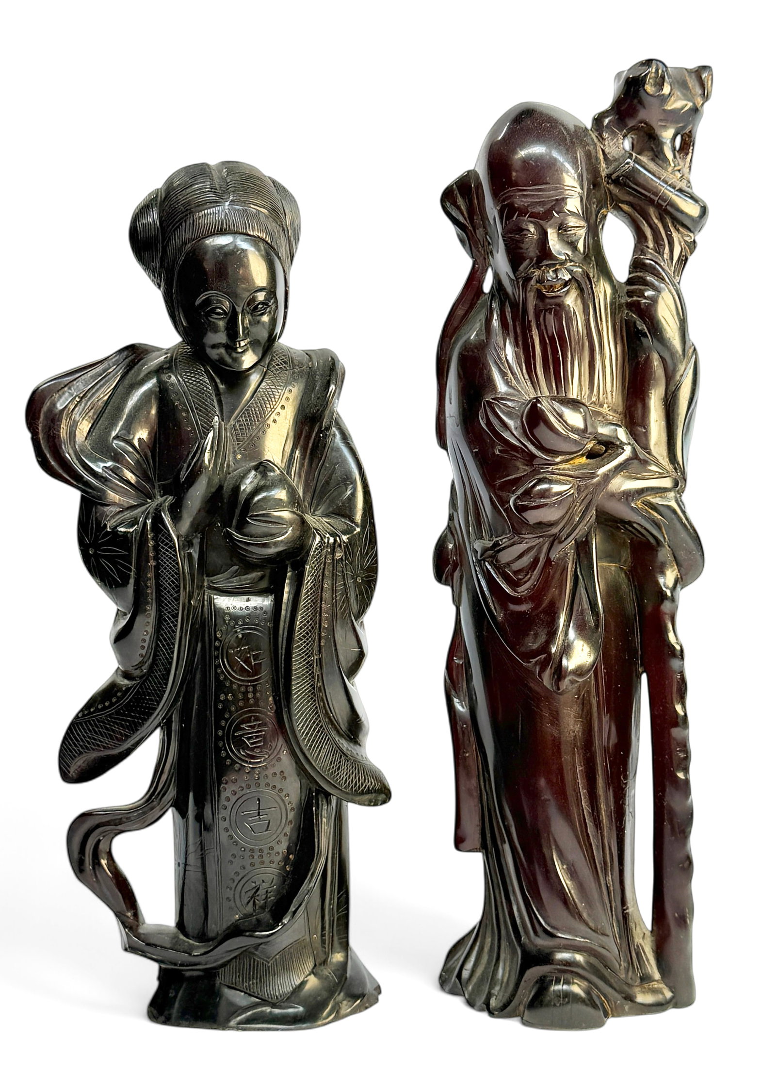Pair of Dark Cherry Amber Chinese Immortal Figures: The man figures look to be in good overall condition, with age-related wear. The lady figure has a crack which runs most of the way around her neck area. It has some residue on its underside, from pre