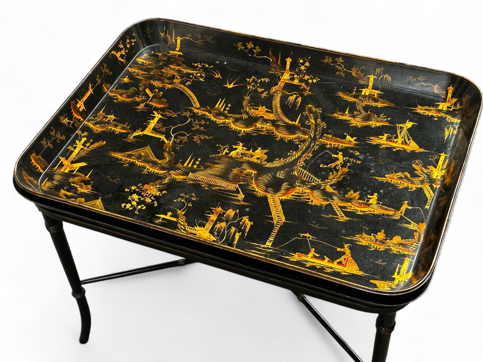 Chinoiserie Regency Style Black Lacquer Tray Table: The removable tray has exquisite Chinese theme gilded designs all over it. The tray has some craquelure to it, but looks to be in good overall condition. The table as a whole is in good overall condit