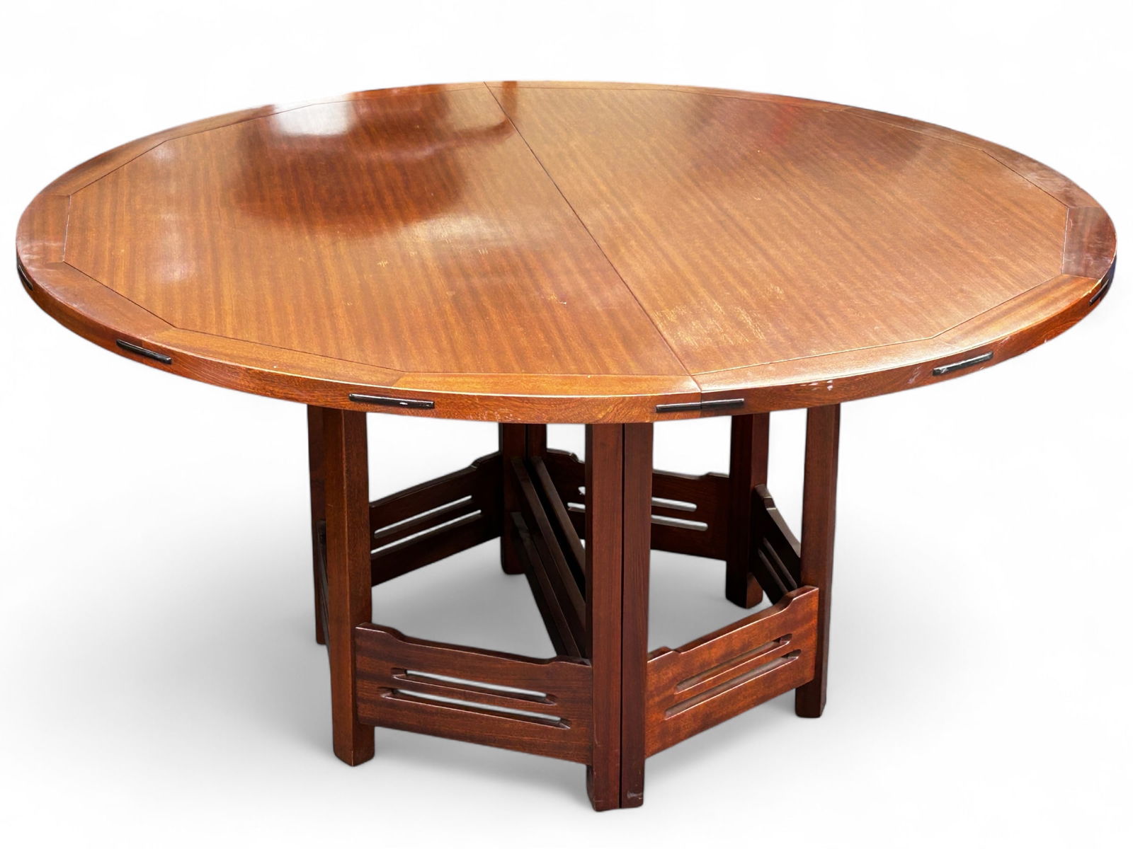 " Antiques by Stickley " Dining Table.: This round light and dark table has two leaves, and is manufactured by Stickley. It has hexagon shaped legs, with a cut out design. The manufacturer's label is on the underside. There are a few scratc