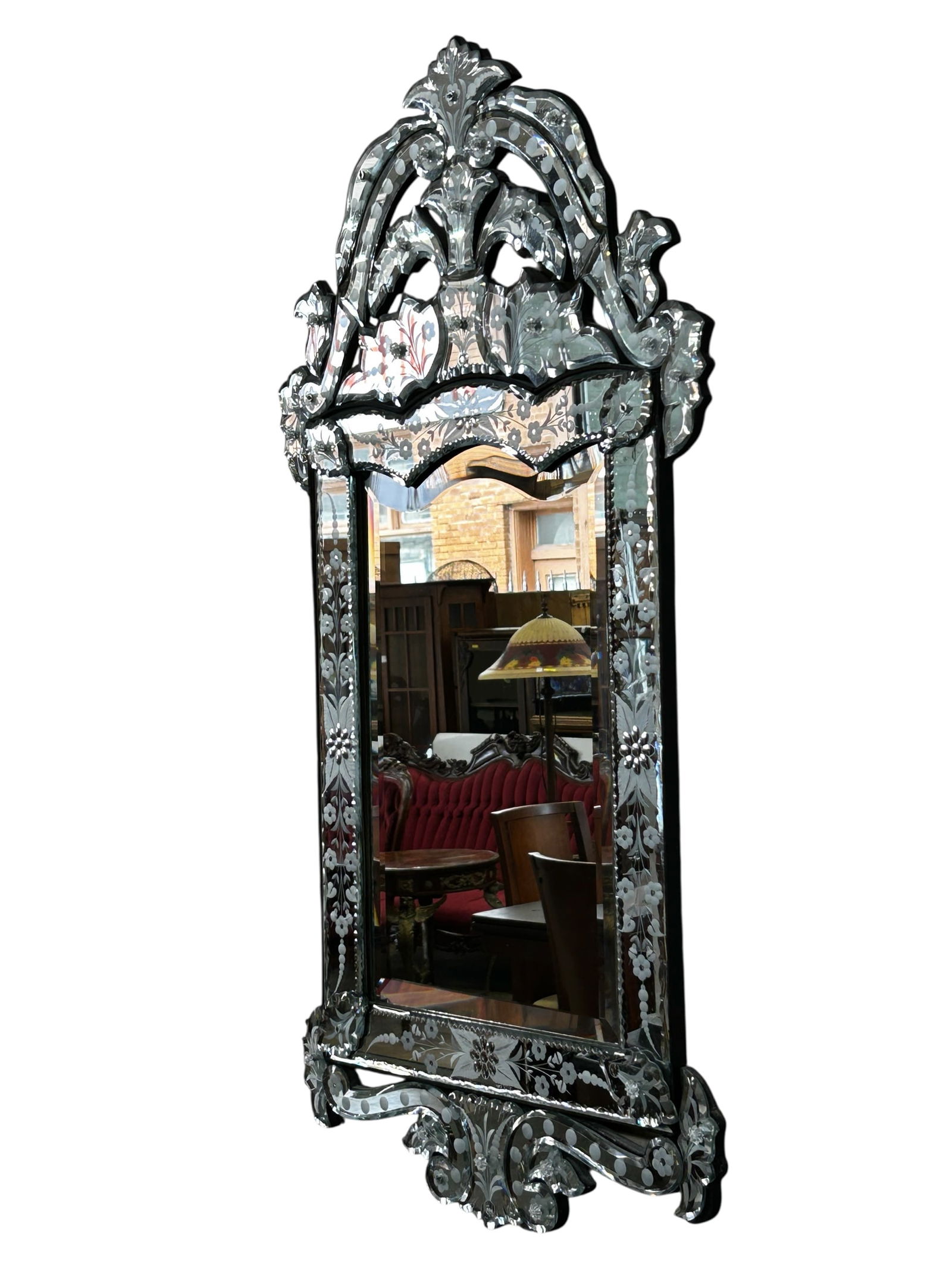 Venetian Etched Glass Mirror.: The mirror features etched and cut bevelled mirror decorative sections. The etchings depict flowers, leaves, and circles. It measures 35 1/2" x 19". There are some scratches and stains on the piece, a