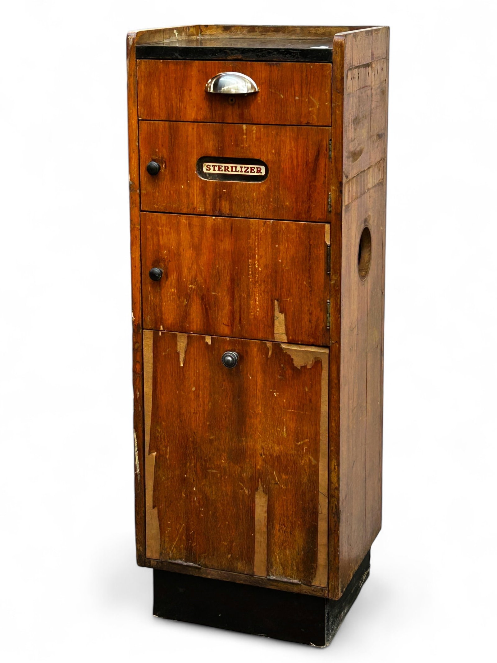 Vintage Sterilizer Cabinet.: This vintage sterilizer cabinet was most likely used in a doctor's office or early barber shop. It has drawers, compartments, and a trash drawer on the bottom. It has chrome and brass handles. It is m