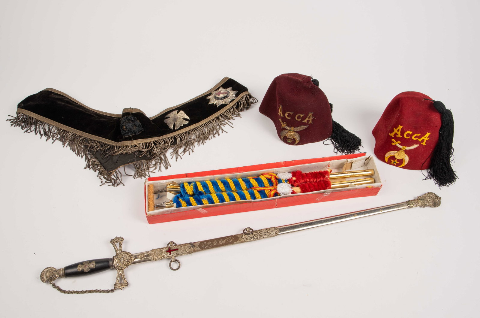 Lot of Mostly Masonic Vintage and Antique Items.: The lot includes the following: a Henderson Ames Co. elaborately decorated sword with scabbard, a ceremonial sash with badges, two Shriner's hats (some moth damage), and a pair of Spanish bullfighting