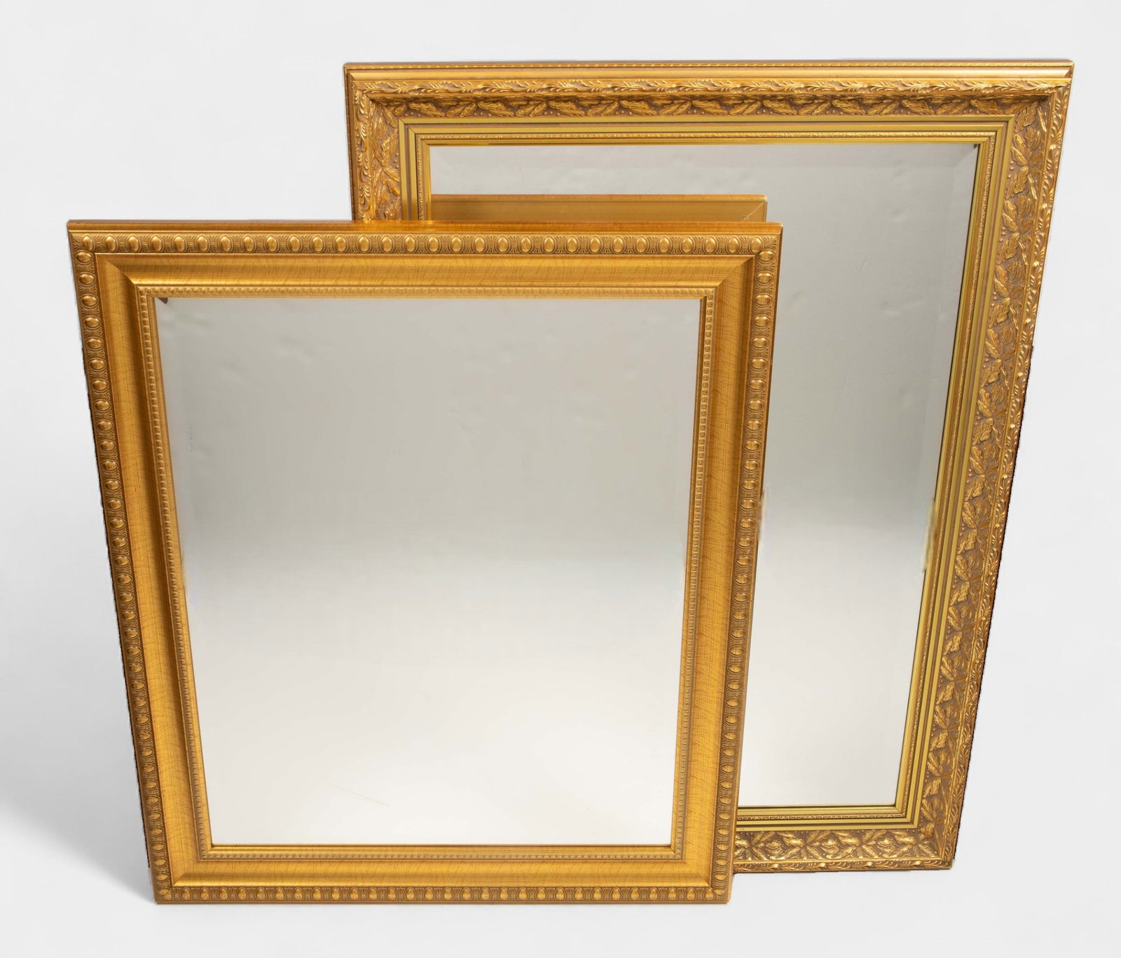 Lot of 2 Bevelled Glass Mirrors w/ Gilded Frames.: One is by the Bombay Company. Both wall mirrors look to be in good cosmetic condition. The larger one measures 42 1/2" x 30 1/2" x 2 1/4". The smaller one measures 30" x 36 1/2" x 1 1/4". Third-party