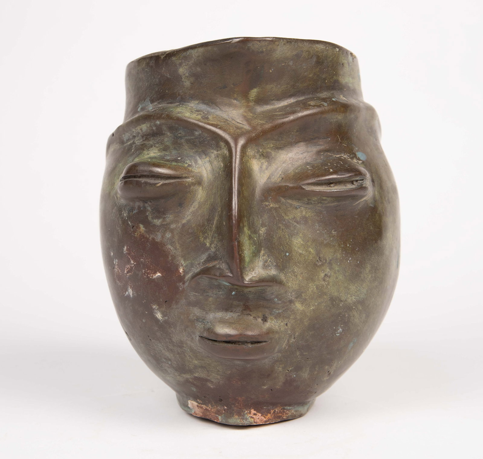 Bronze Portrait Pitcher, Constantin Brancusi Style: The heavy bronze pitcher depicts an abstract linear face in the style of Constantin Brancusi. The piece measures 6 1/2" x 5 1/2" x 8 1/4". It weighs 7.7 Pounds. There are scratches and stains on the p